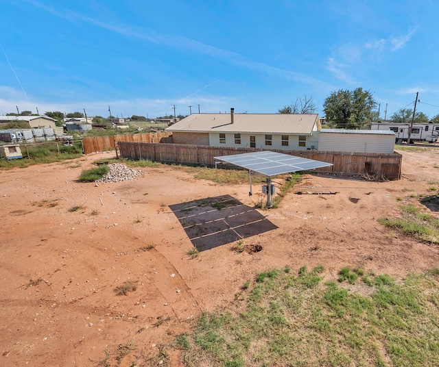 back of property featuring solar panels