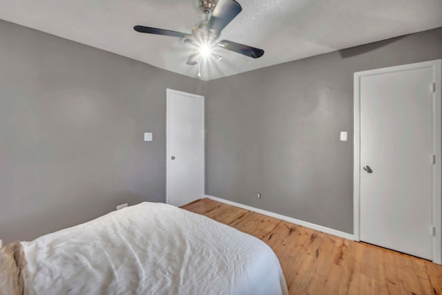 bedroom with hardwood / wood-style floors and ceiling fan