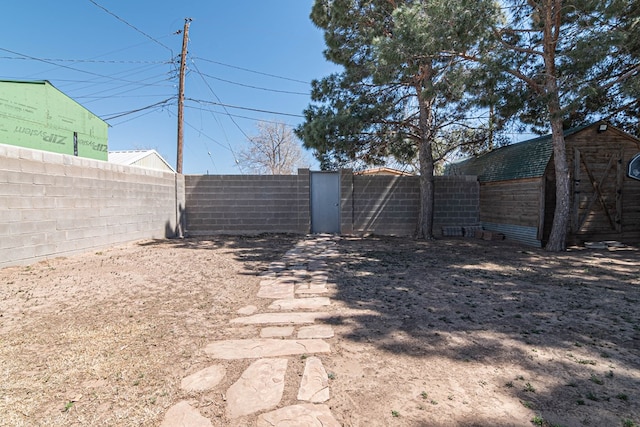 view of yard featuring a fenced backyard and a gate