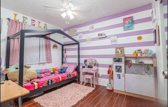 bedroom featuring a textured ceiling and wood finished floors