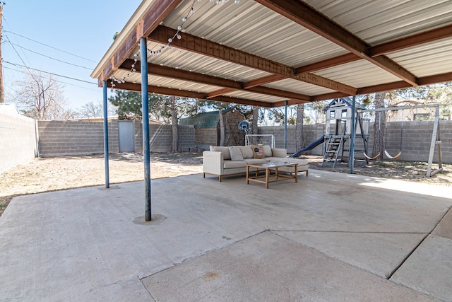 view of patio / terrace featuring outdoor lounge area, a playground, and a fenced backyard