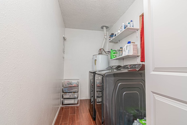 washroom featuring wood finish floors, water heater, laundry area, independent washer and dryer, and a textured ceiling