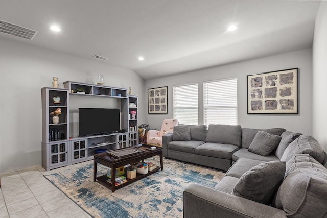 living room featuring light tile patterned floors and vaulted ceiling