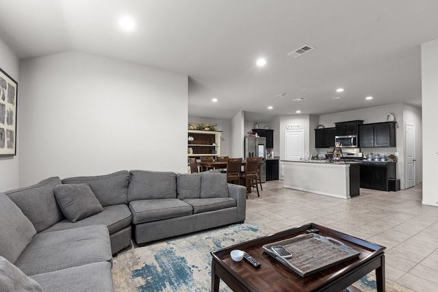 living room with light tile patterned flooring and lofted ceiling