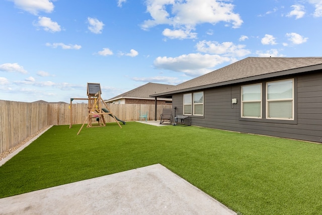 view of yard featuring a patio area and a playground