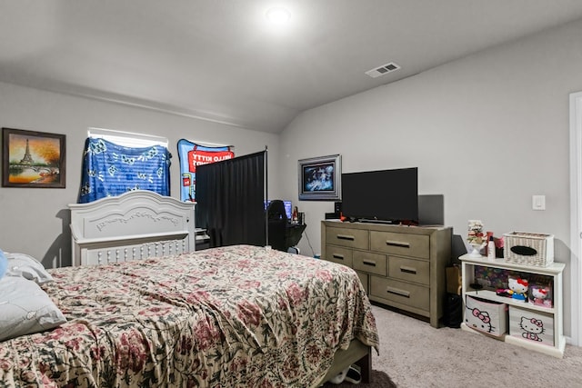 bedroom with light colored carpet and lofted ceiling