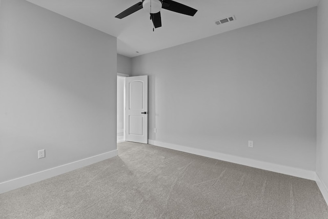 empty room with a ceiling fan, carpet, visible vents, and baseboards