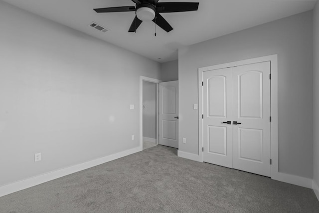 unfurnished bedroom with ceiling fan, visible vents, baseboards, a closet, and carpet