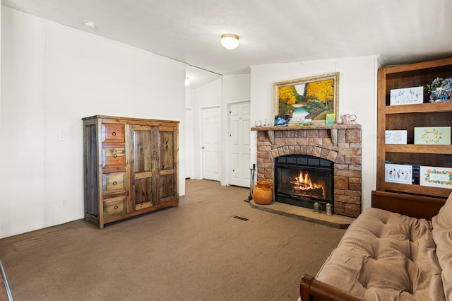 carpeted living room with lofted ceiling, a fireplace, and visible vents