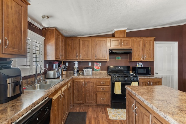 kitchen with ornamental molding, brown cabinets, under cabinet range hood, black appliances, and a sink