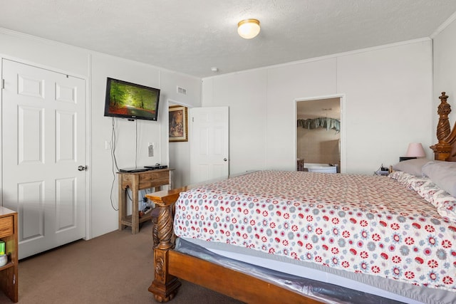 bedroom with a textured ceiling, ornamental molding, carpet flooring, and visible vents