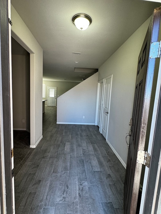 unfurnished room featuring dark wood-type flooring