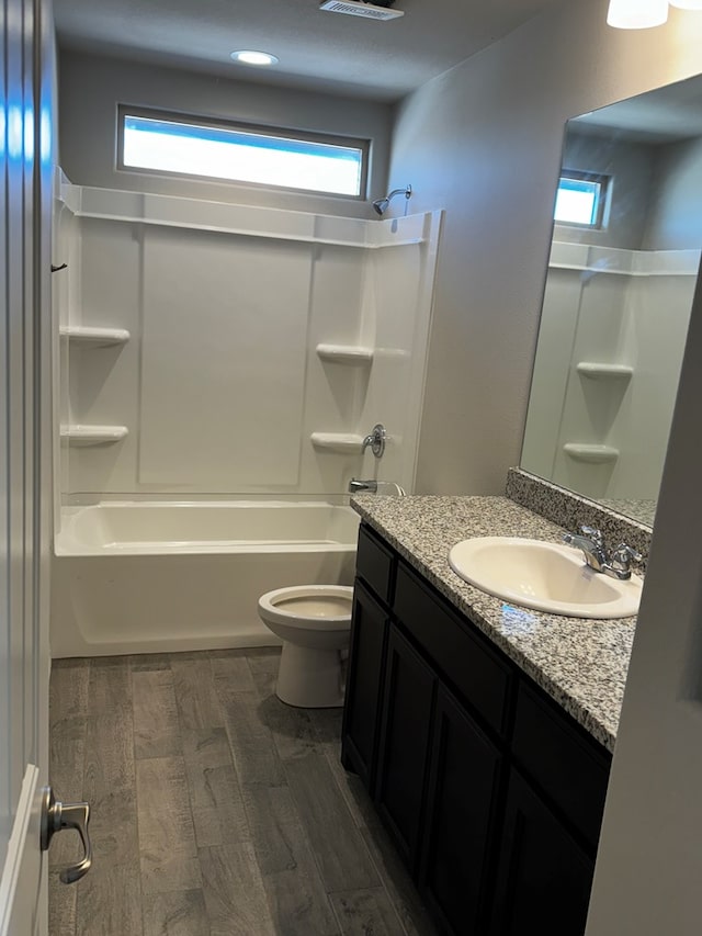 full bathroom with bathing tub / shower combination, vanity, hardwood / wood-style floors, and plenty of natural light