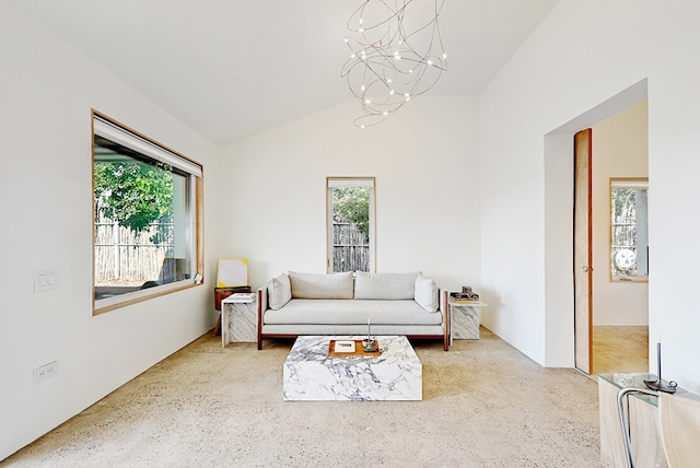 living room featuring a chandelier and vaulted ceiling