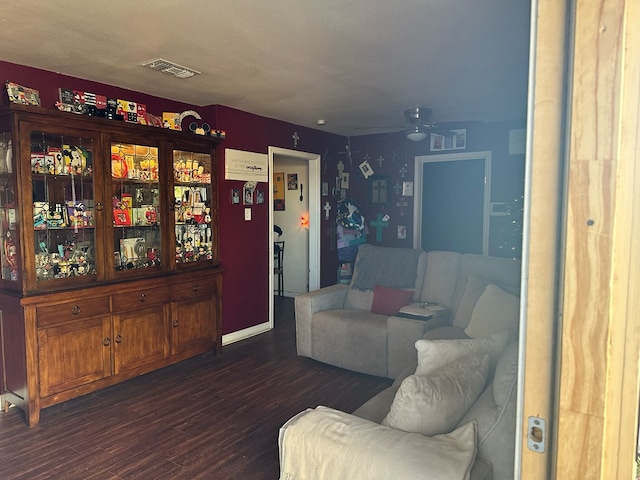 living room with ceiling fan, dark wood-type flooring, and a textured ceiling