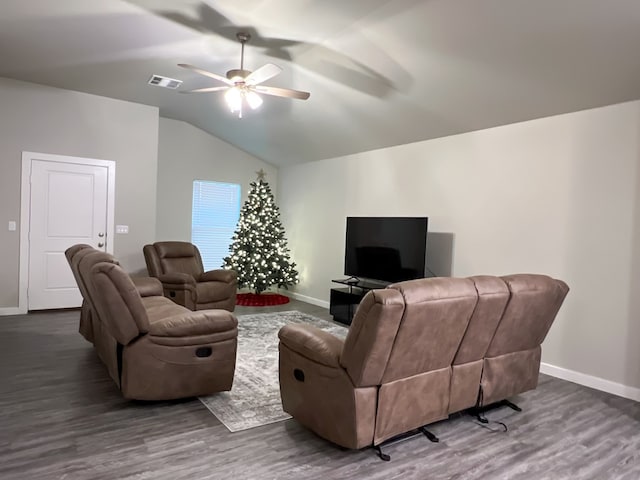 living room featuring hardwood / wood-style flooring, ceiling fan, and vaulted ceiling