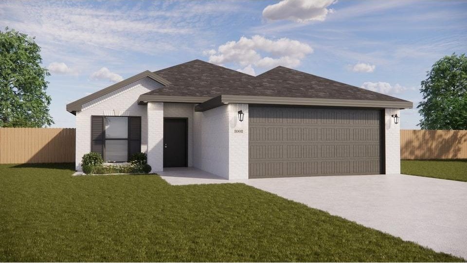 view of front facade with a garage and a front yard