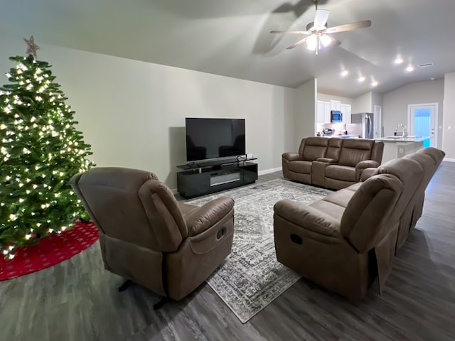 living room with dark hardwood / wood-style flooring, sink, vaulted ceiling, and ceiling fan