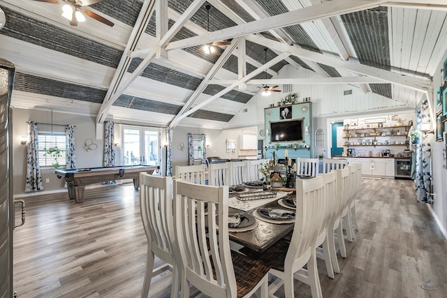 dining area featuring wood-type flooring, indoor bar, billiards, beamed ceiling, and wine cooler