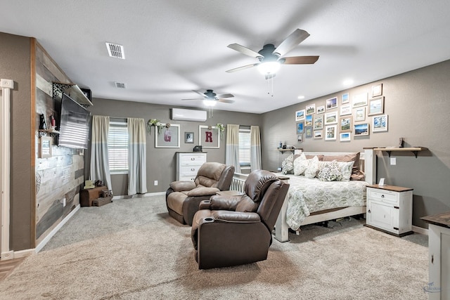 bedroom featuring multiple windows, ceiling fan, light carpet, and a wall mounted air conditioner