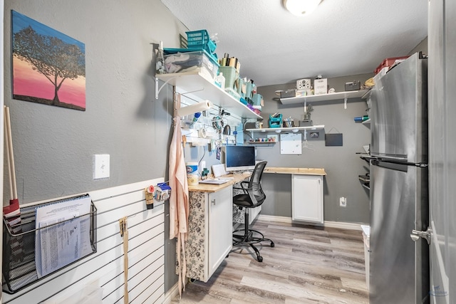 office area featuring a textured ceiling and light hardwood / wood-style flooring