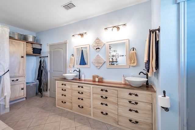 bathroom with tile patterned flooring and vanity