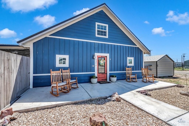 back of property featuring a storage shed and a patio area