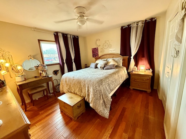 bedroom featuring a ceiling fan and dark wood-style flooring