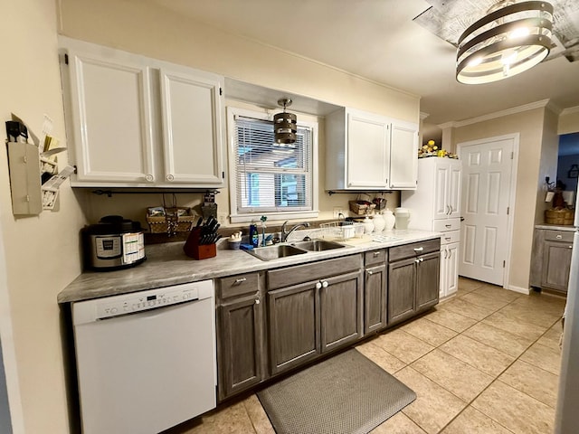 kitchen with light tile patterned floors, ornamental molding, a sink, white cabinets, and dishwasher