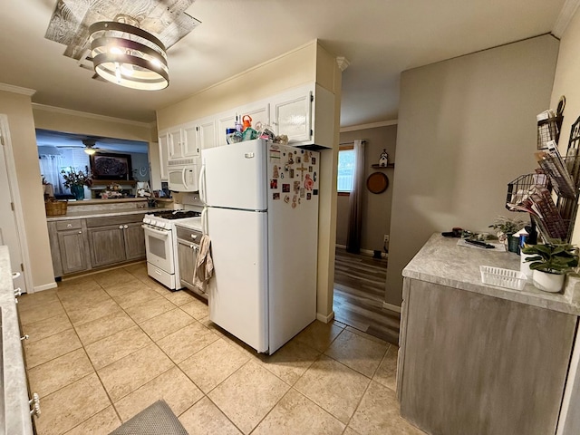 kitchen with white appliances, a ceiling fan, light tile patterned flooring, light countertops, and crown molding