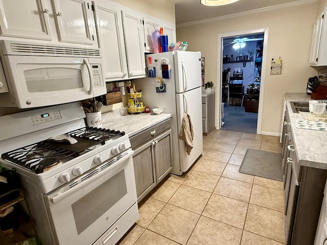 kitchen featuring white cabinetry, white appliances, crown molding, light countertops, and light tile patterned floors