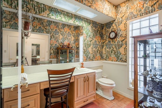 bathroom featuring tile patterned flooring, vanity, and toilet