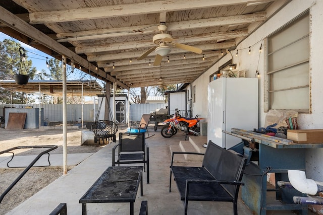 view of patio featuring a shed, fence private yard, and a ceiling fan