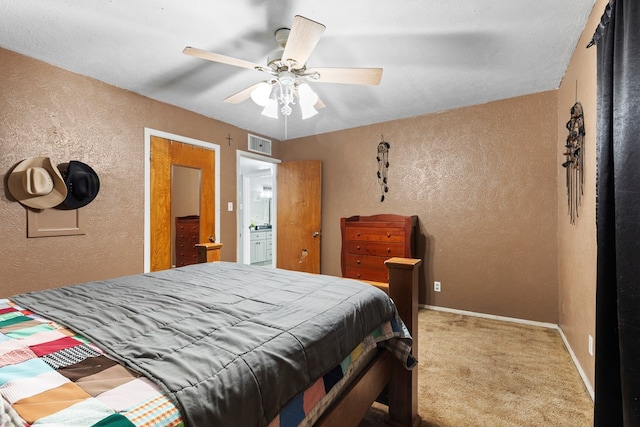 bedroom featuring light carpet, baseboards, visible vents, a textured wall, and ceiling fan