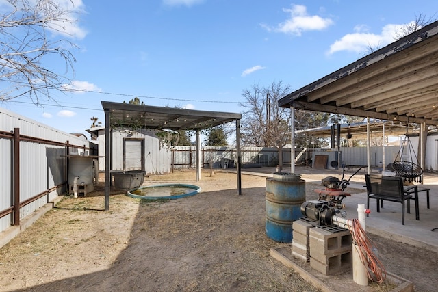 exterior space featuring a shed, a fenced backyard, and an outbuilding