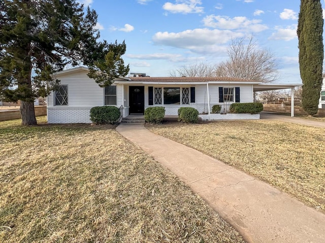 single story home featuring a carport and a front yard