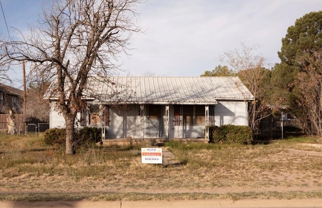 ranch-style home with metal roof