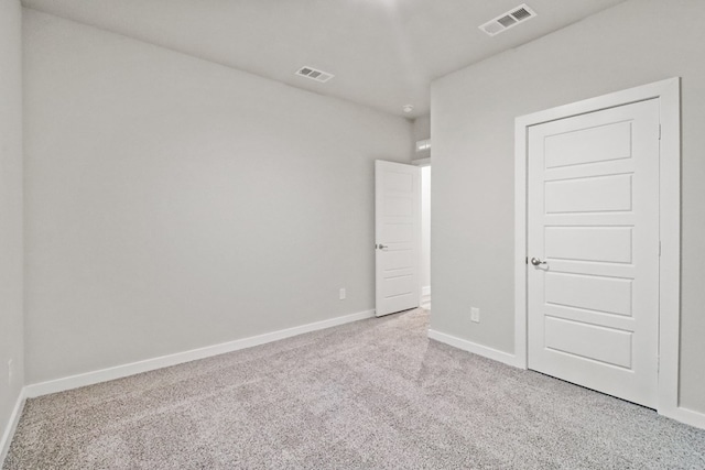 unfurnished bedroom featuring light carpet