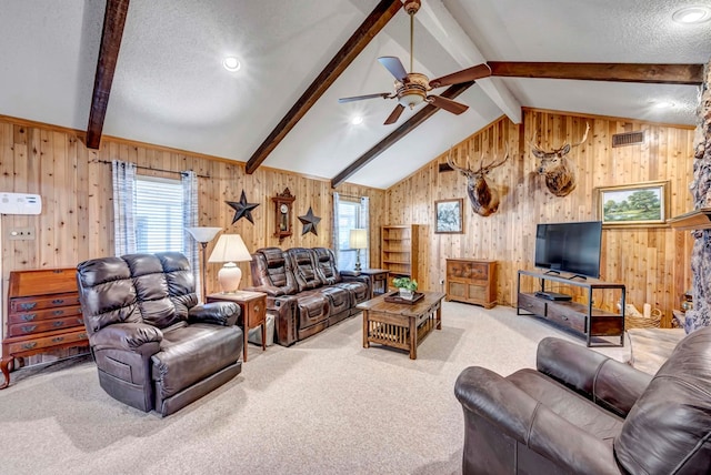 living room featuring carpet floors, lofted ceiling with beams, wooden walls, and a textured ceiling