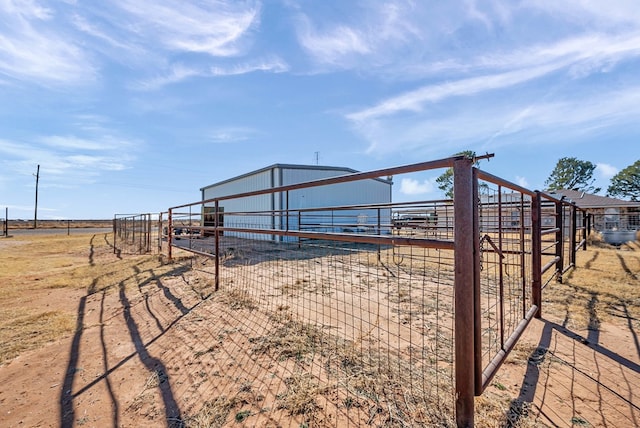 view of yard featuring an outdoor structure and a rural view