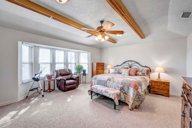 bedroom featuring ceiling fan, light carpet, and a textured ceiling