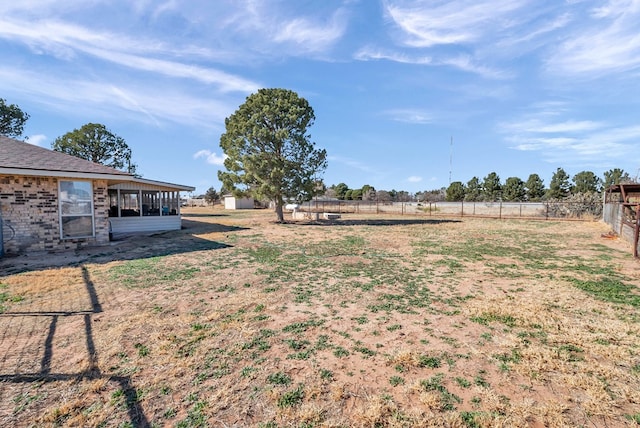 view of yard featuring a rural view and a shed