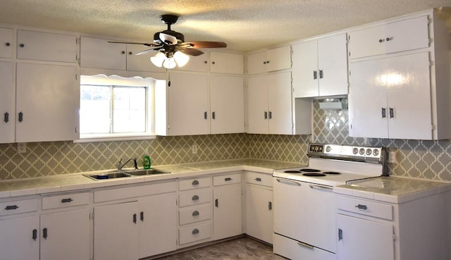 kitchen featuring white electric range oven, tasteful backsplash, white cabinetry, and sink