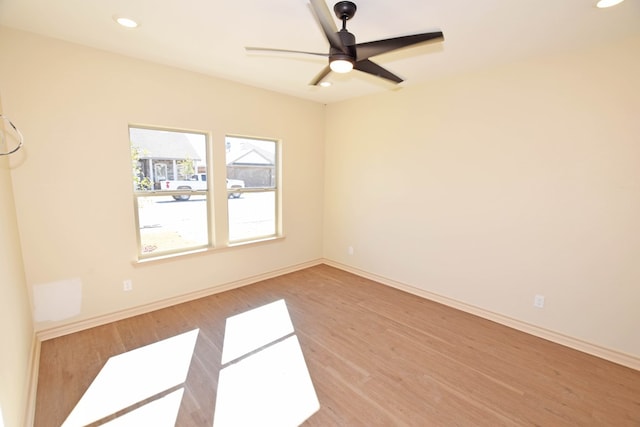 spare room with ceiling fan and wood-type flooring