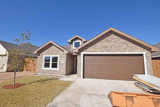 view of front of house with a garage and a front lawn