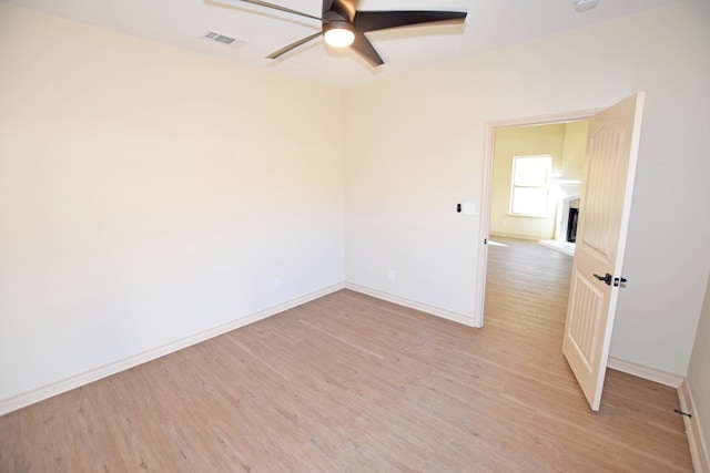 spare room featuring light wood-type flooring and ceiling fan