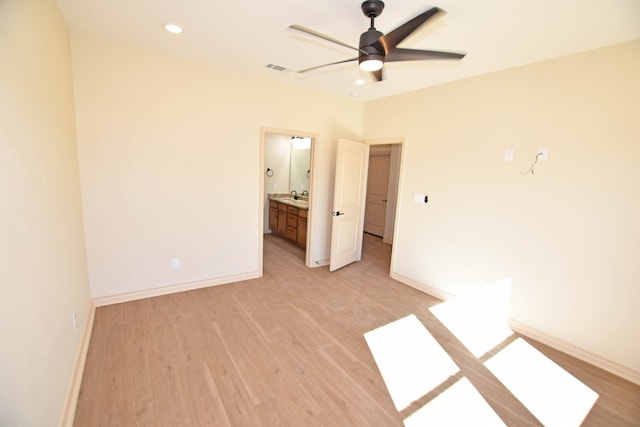 empty room with ceiling fan, sink, and light hardwood / wood-style floors