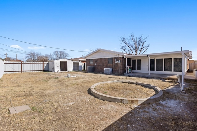 rear view of property featuring central AC unit and a shed