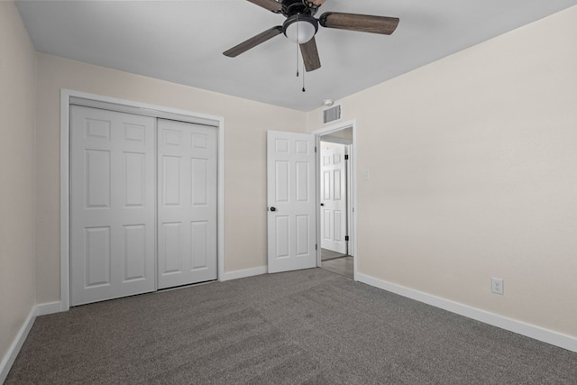 unfurnished bedroom with dark carpet, a closet, and ceiling fan