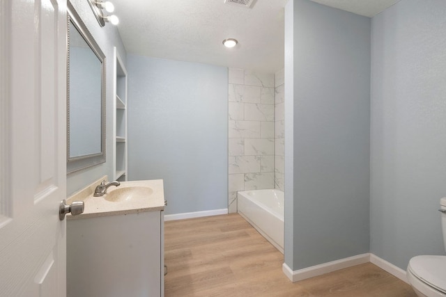 full bathroom with toilet, baseboards, wood finished floors, and vanity